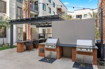 Entertainment pavilion featuring an outdoor kitchen with gas grill, bar seating and fireplace